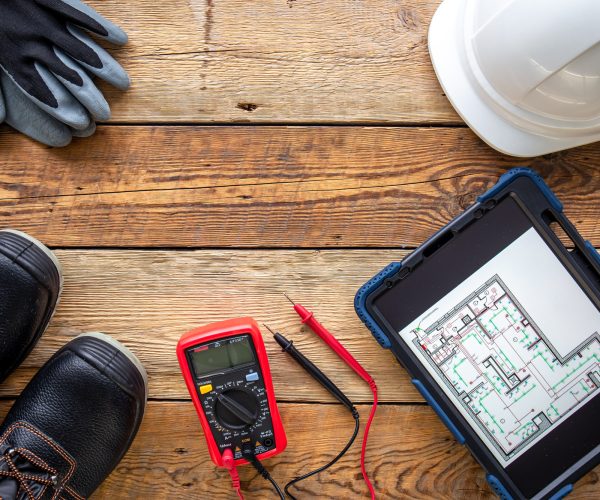 Flat lay composition with electrician's tools and accessories.